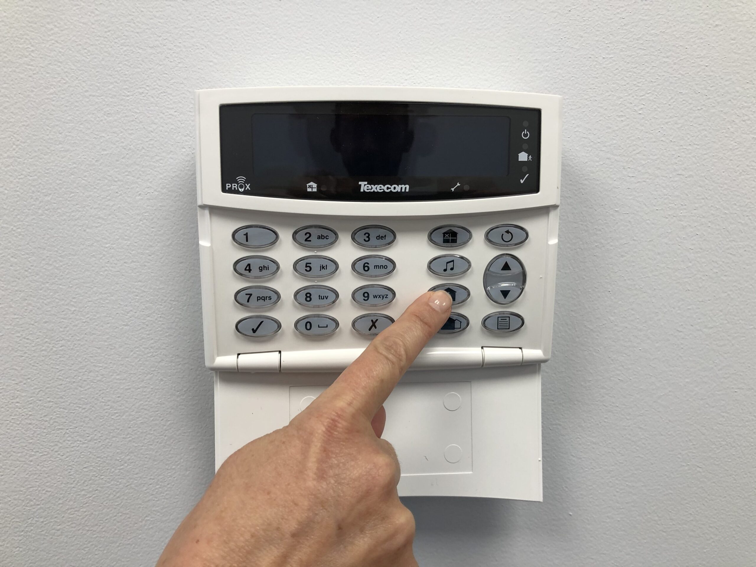 Commercial intrusion alarm keypad and control panel installed on a wall