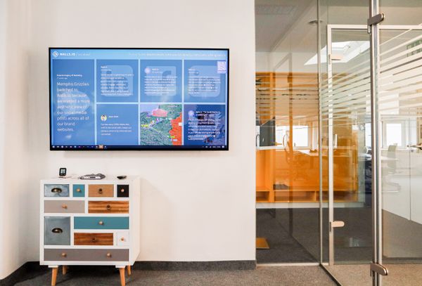 Modern office with a wall-mounted digital presentation display